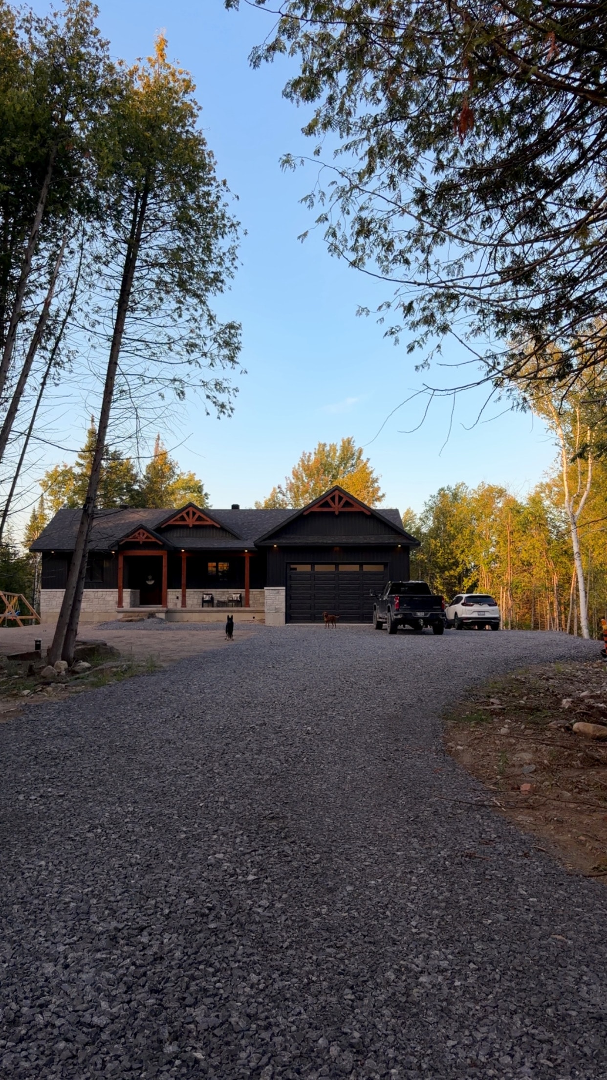 Cottage home exterior surrounded by autumn trees